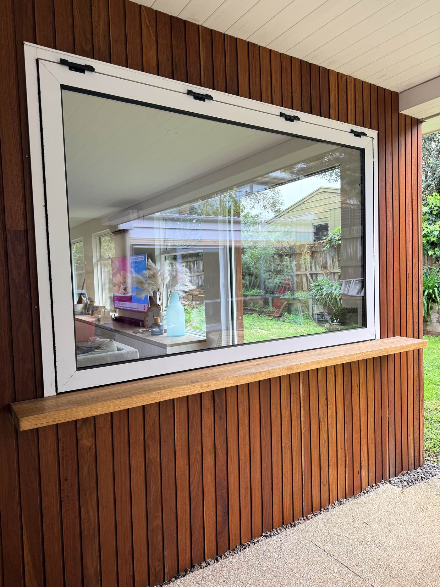 Timber-framed picture window with built-in seat ledge