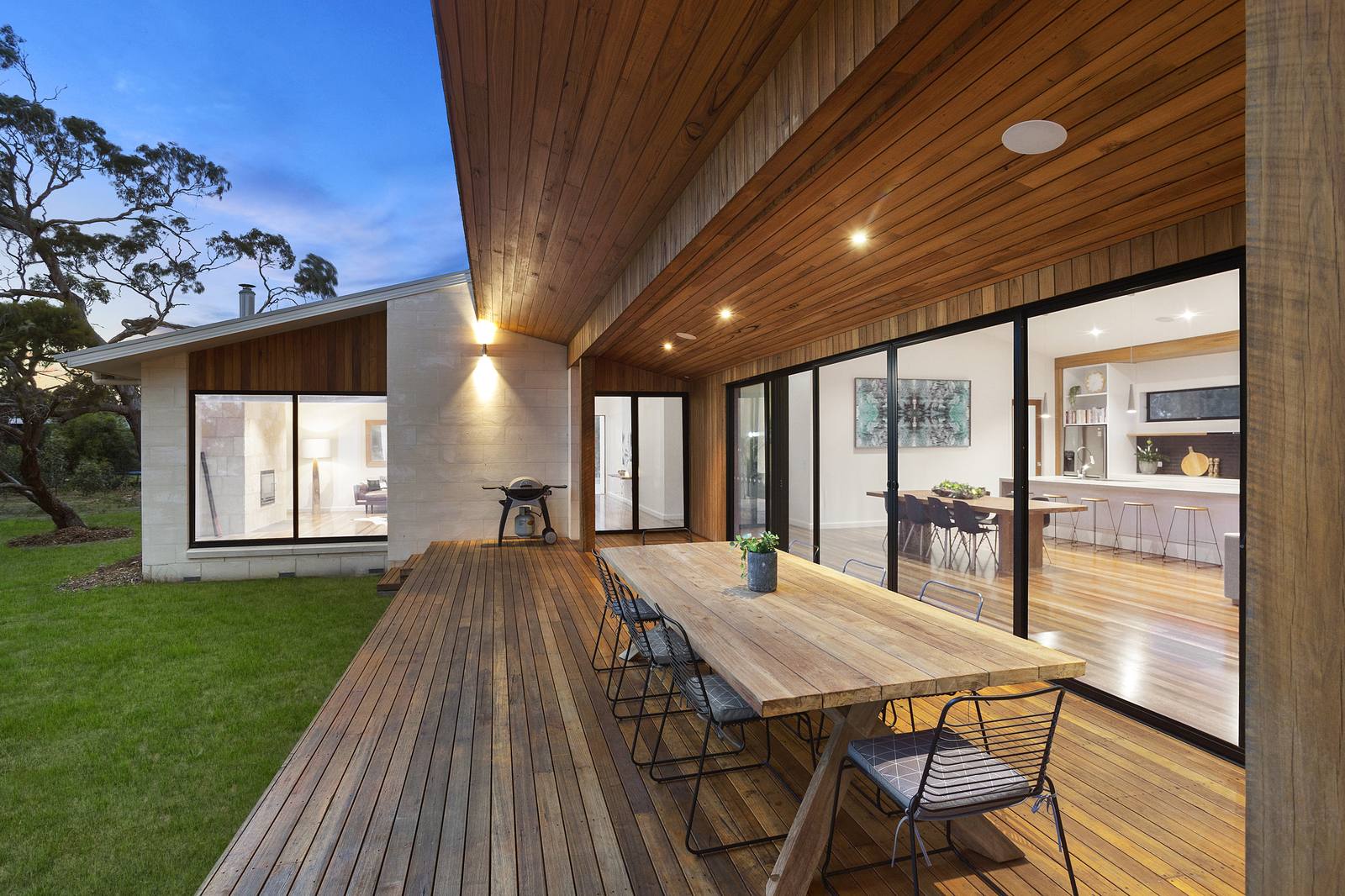 Outdoor deck and dining area at dusk, Stibbard Constructions build